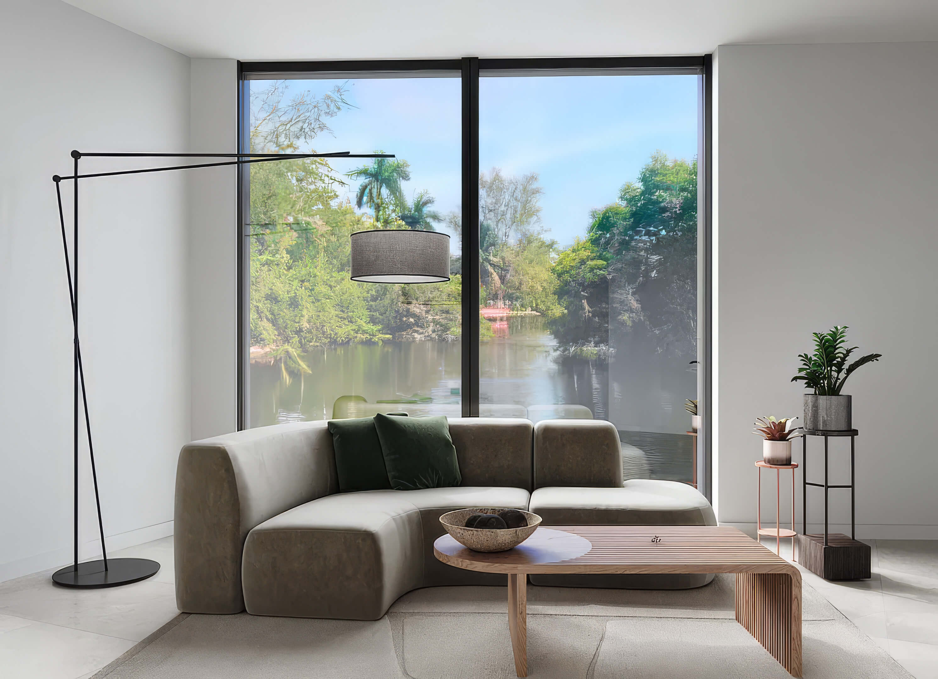 Living room at Canal by IQ with floor-to-ceiling windows, modern sofa and canal views