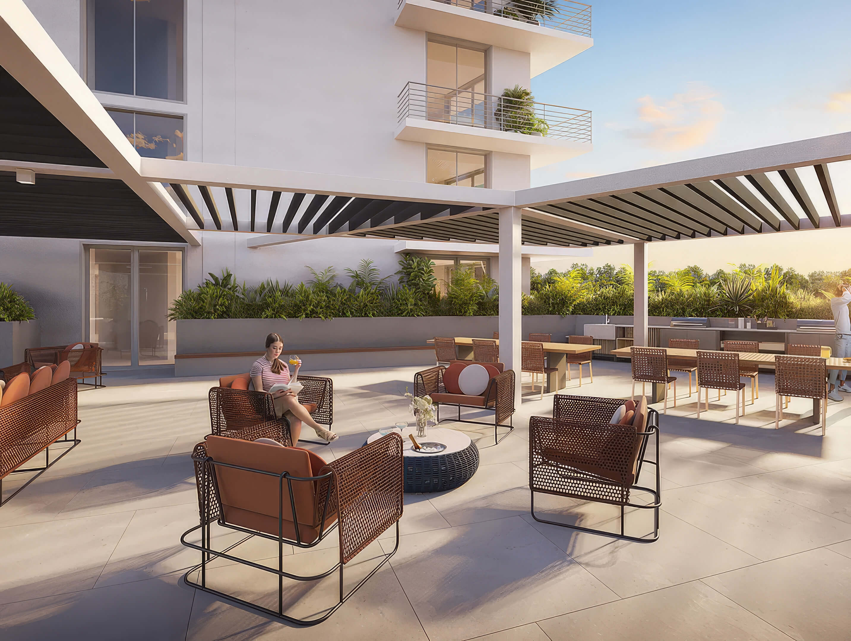 Outdoor lounge and dining area at Canal by IQ with pergola shade, seating and summer kitchen
