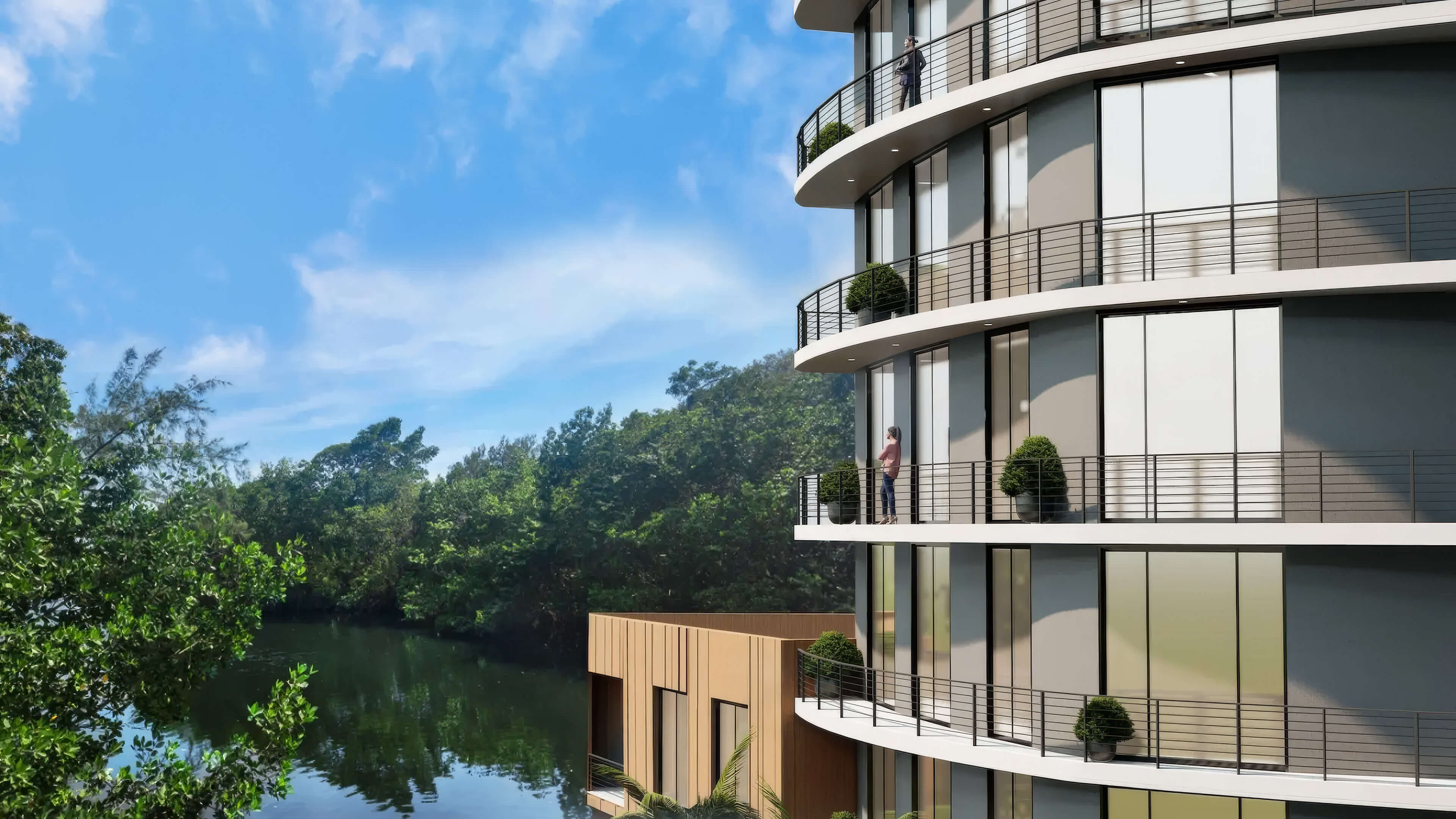 Waterfront residence balconies at Canal by IQ overlooking lush greenery and calm canal views