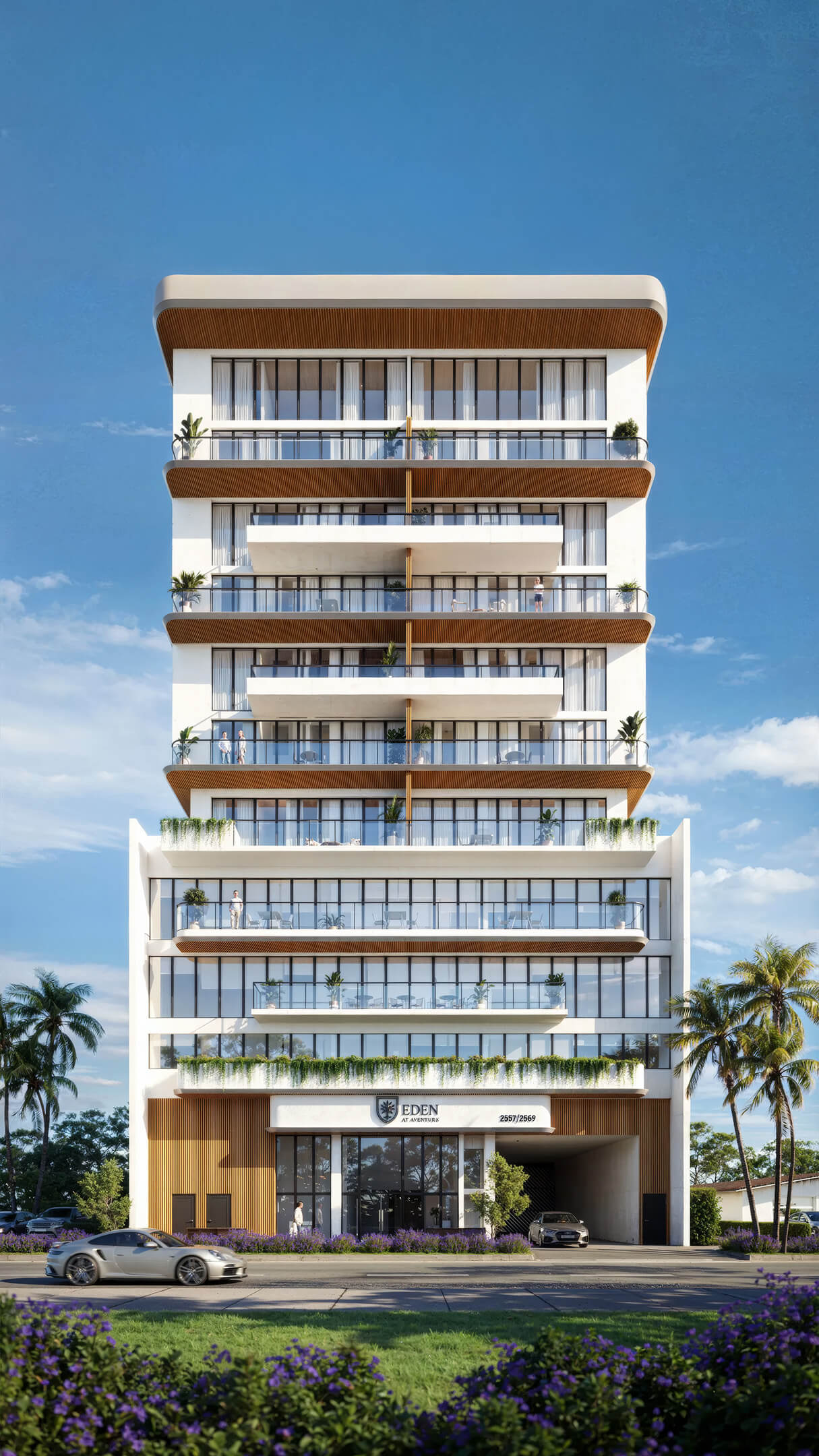 Contemporary daytime exterior view of EDEN Residences with balconies, palm trees and blue sky