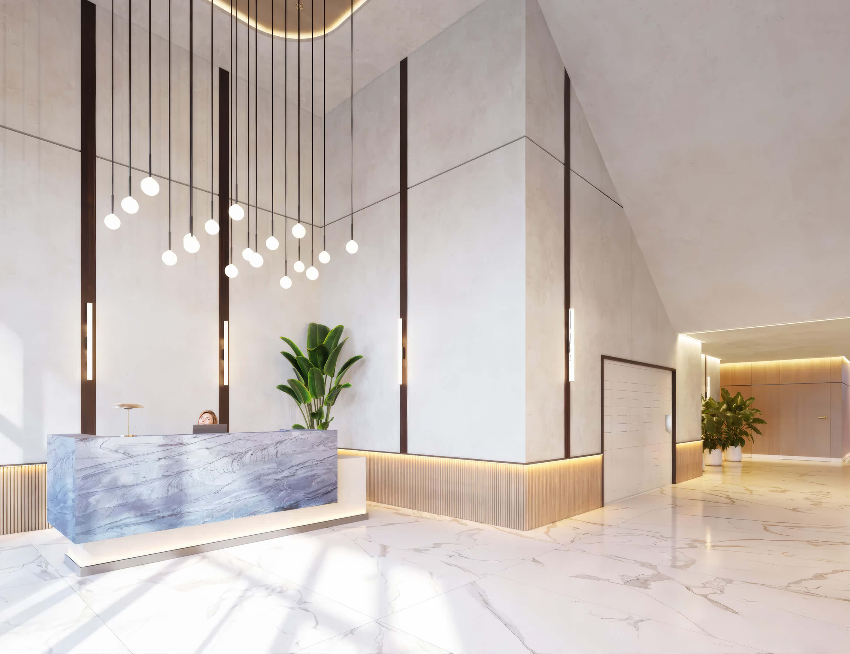 Elegant lobby reception at EDEN Residences with marble desk, pendant lighting and modern finishes