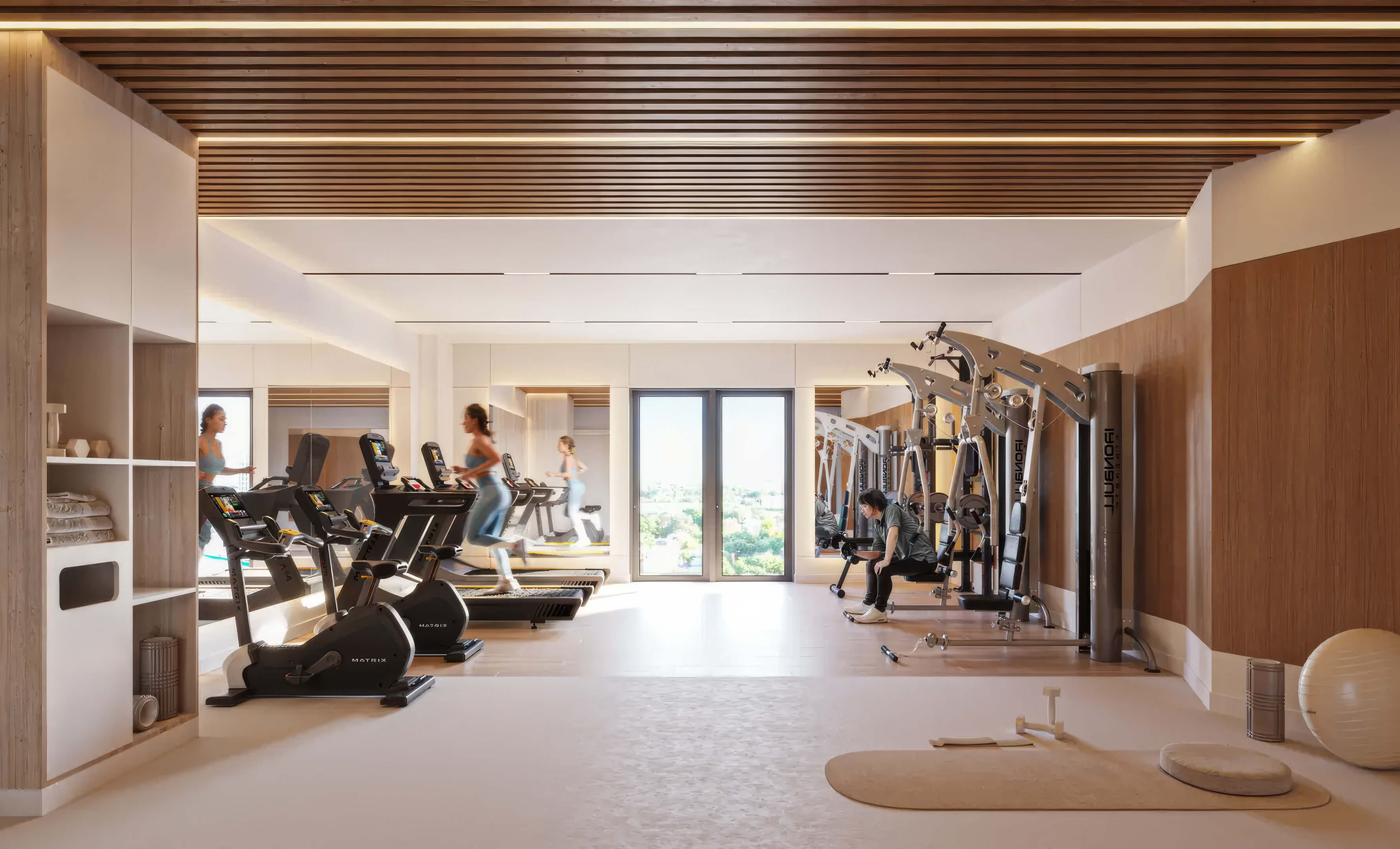 Fitness center at EDEN Residences with cardio equipment, strength machines and modern wellness amenities