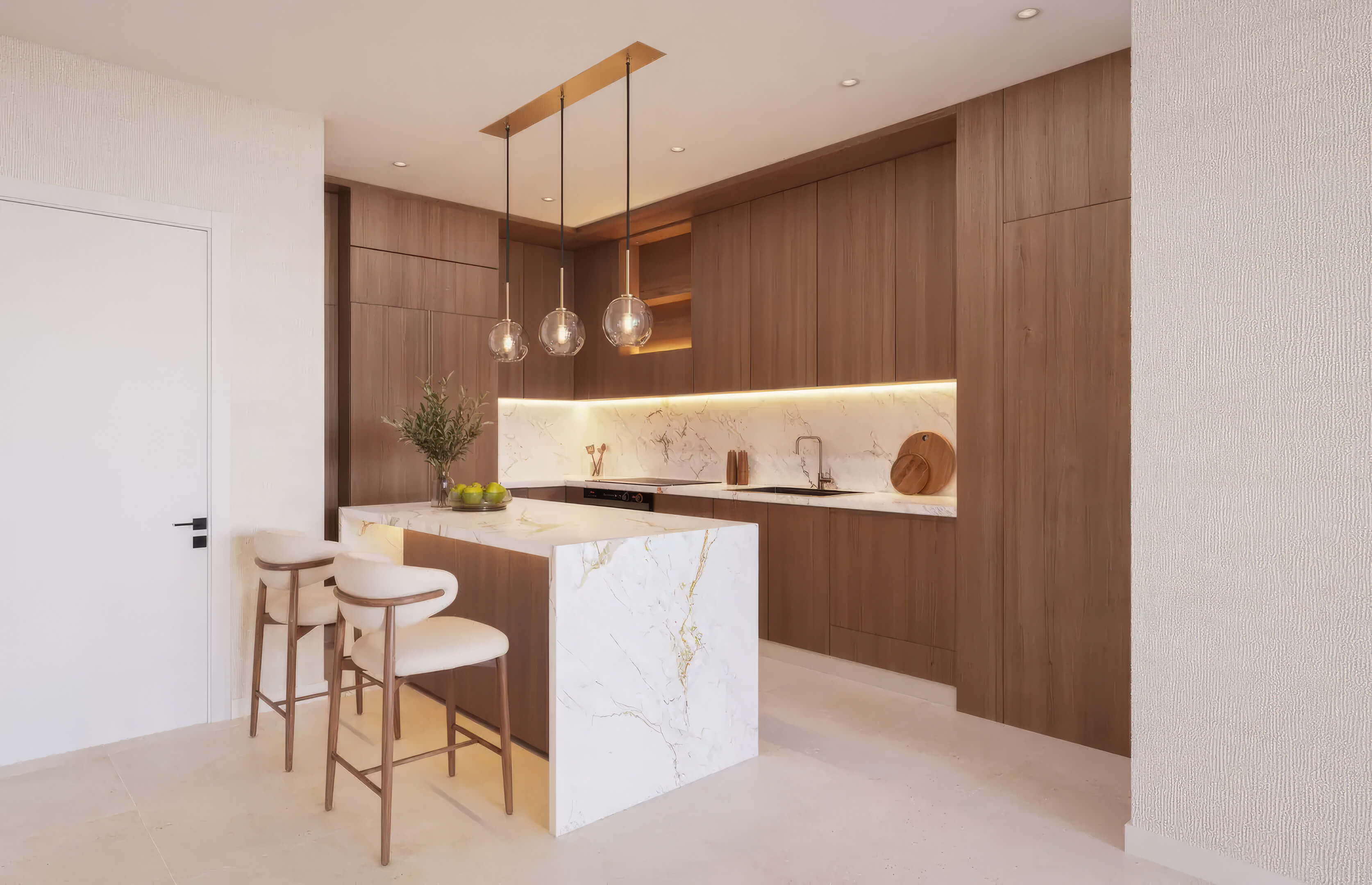 Modern kitchen at EDEN Residences with marble island, wood cabinetry and pendant lighting