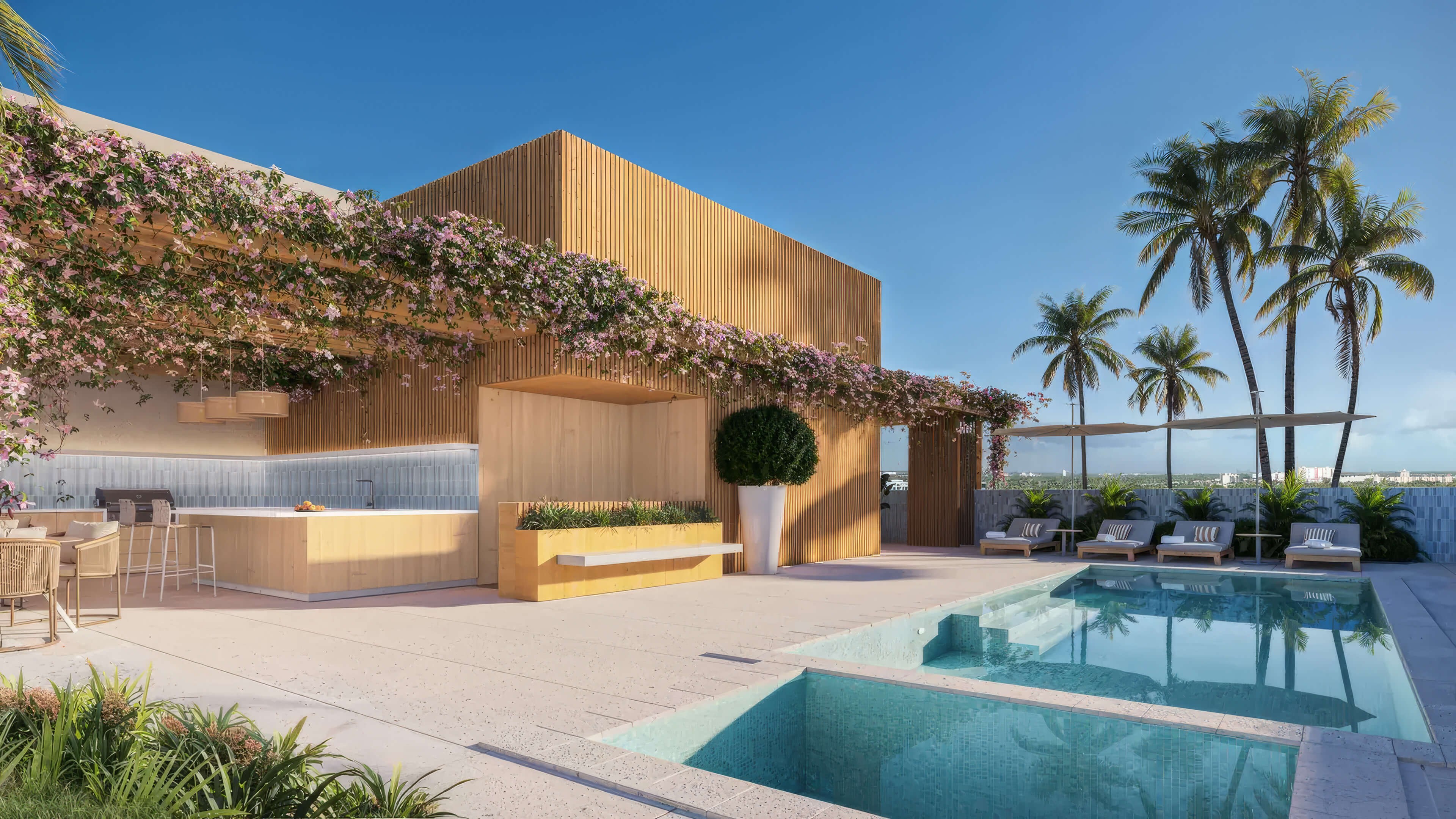 Rooftop pool deck at EDEN Residences with lounge chairs, palm trees and outdoor entertainment area